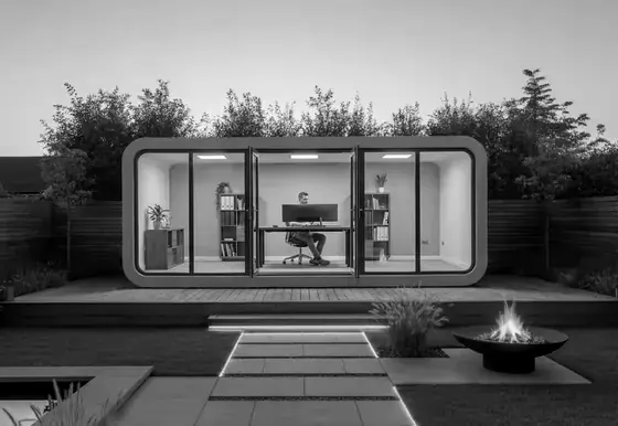 A GoMo garden pod lit from inside at dusk