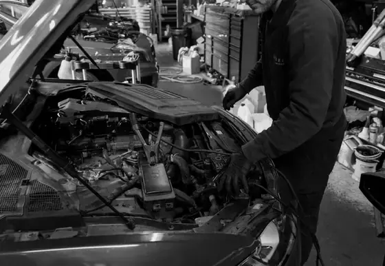 A Wheels VT technician working under a bonnet
